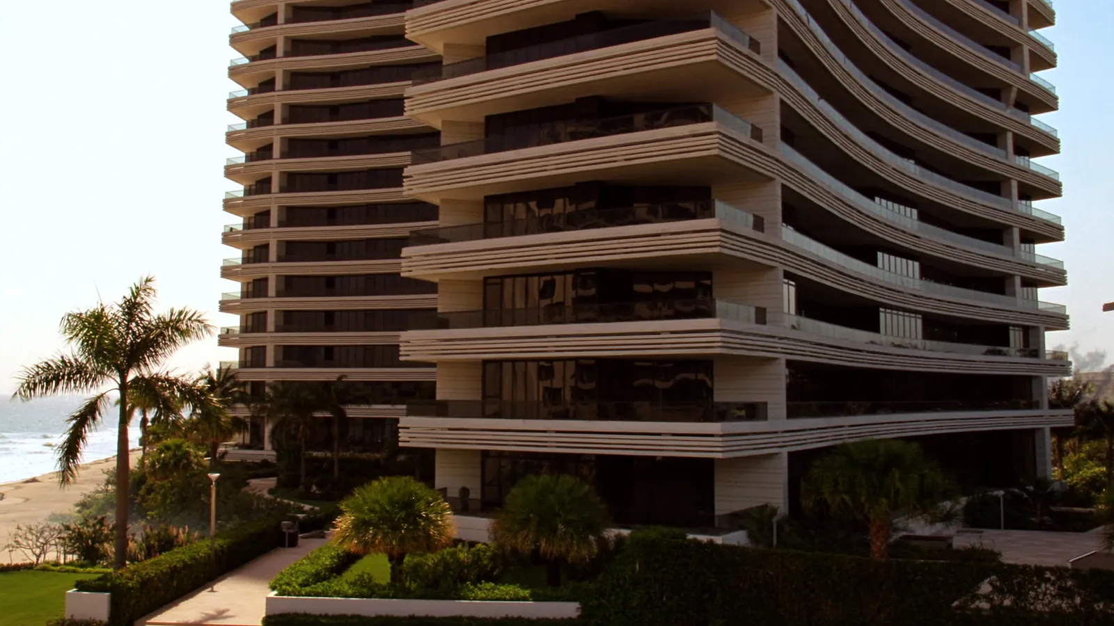 Luxury oceanfront condominium tower framed by manicured palms in Bal Harbour, Florida