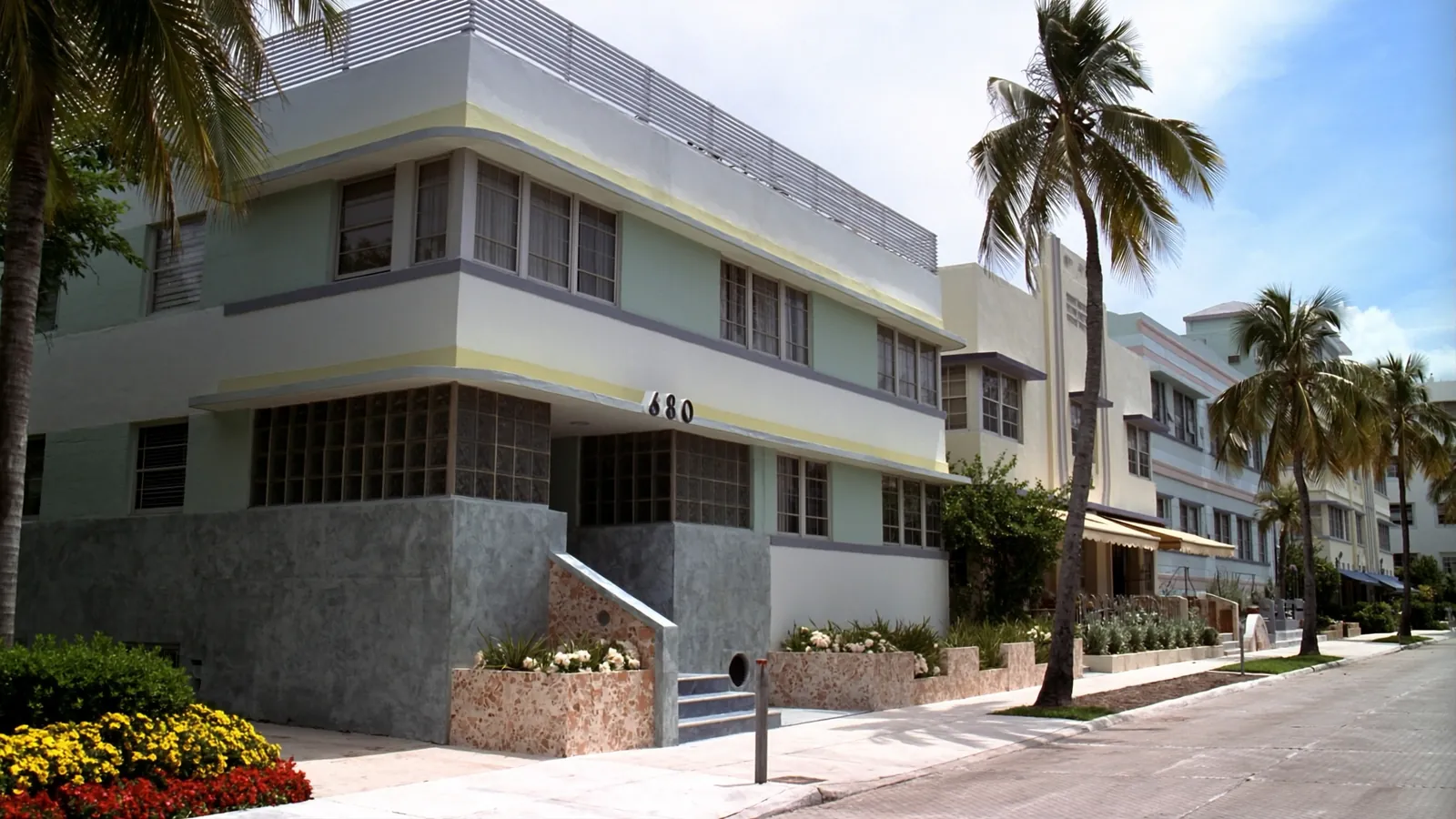 Pastel Art Deco apartment buildings lined with palm trees in Miami Beach, Florida
