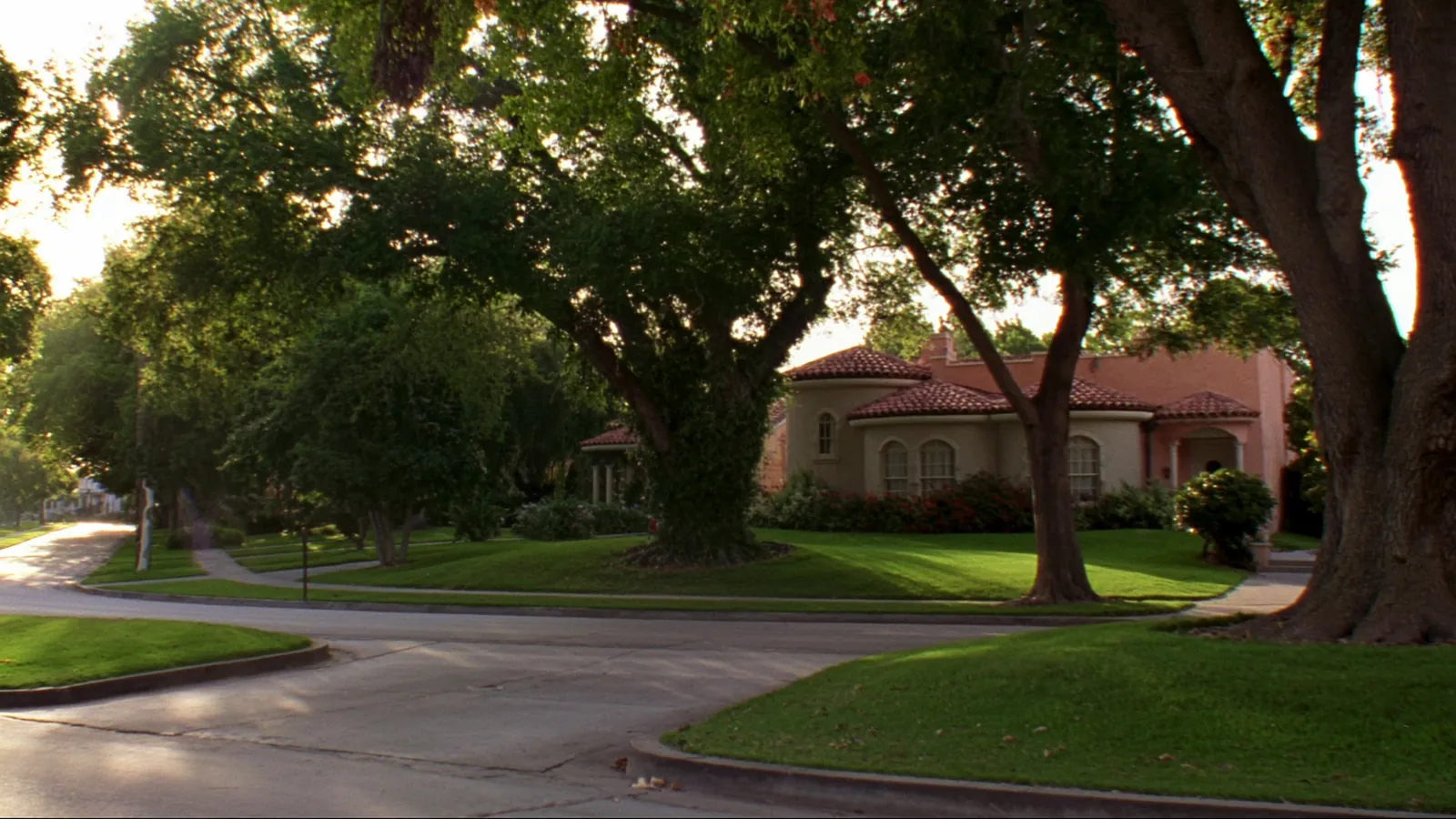 An older family home under mature oak trees in South Florida