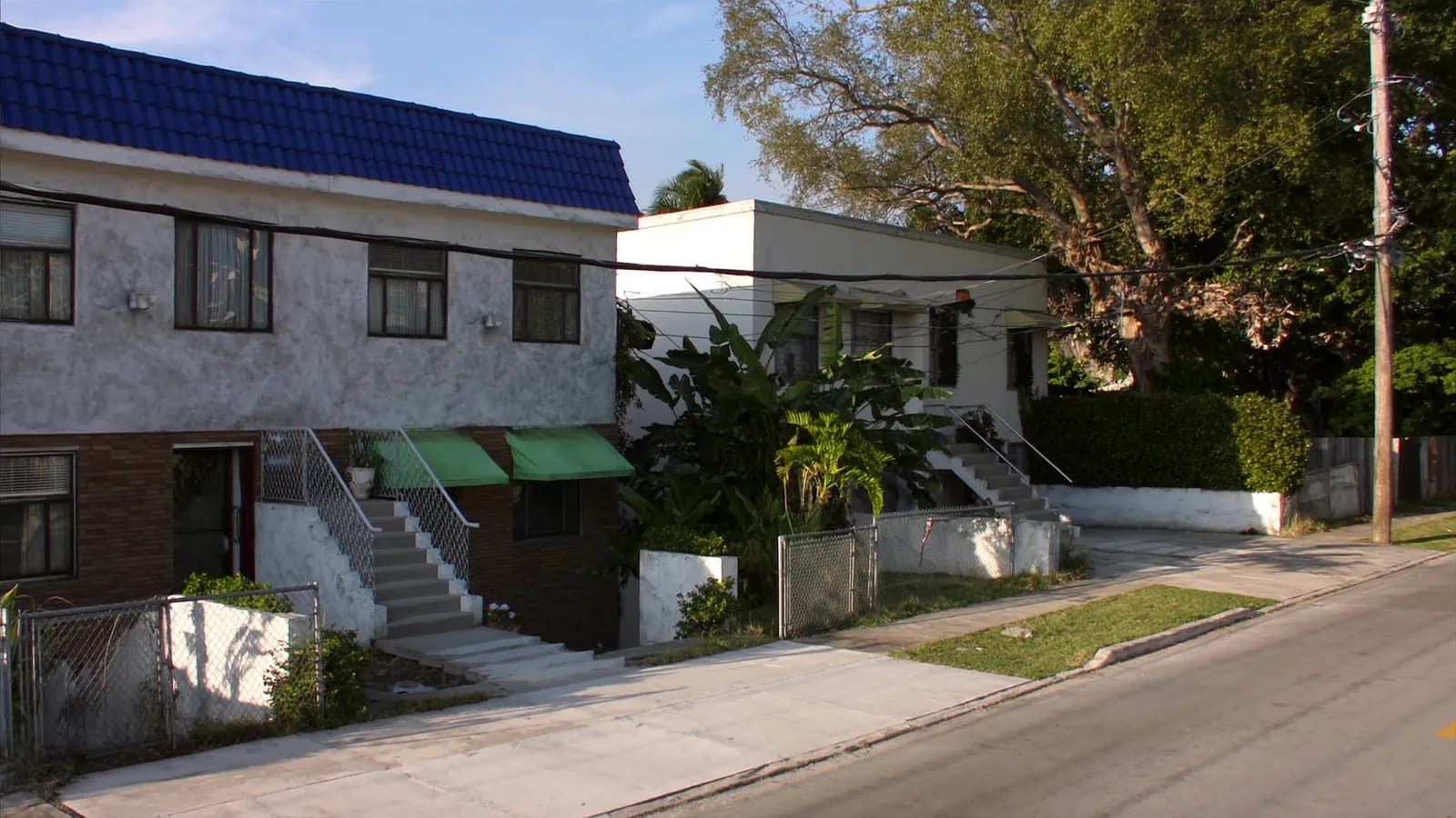 Small residential duplex buildings on an older Miami street