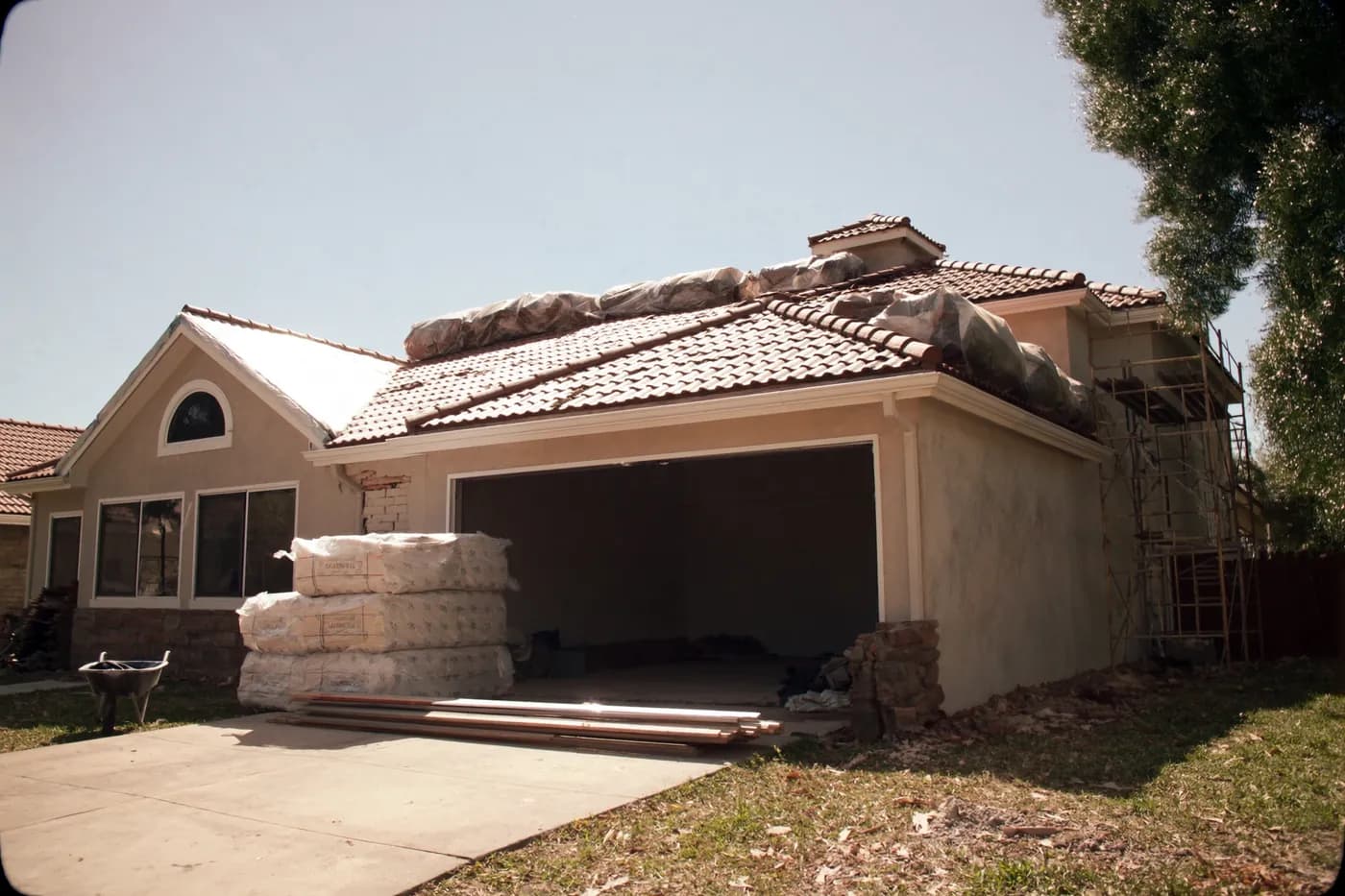 A South Florida house mid-renovation with a partially replaced tile roof