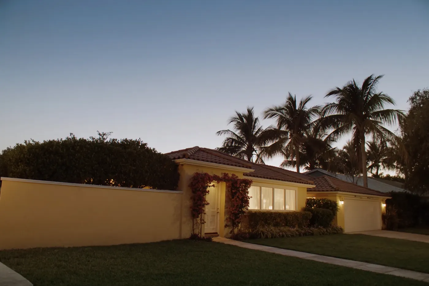 A South Florida single-family home exterior at dusk